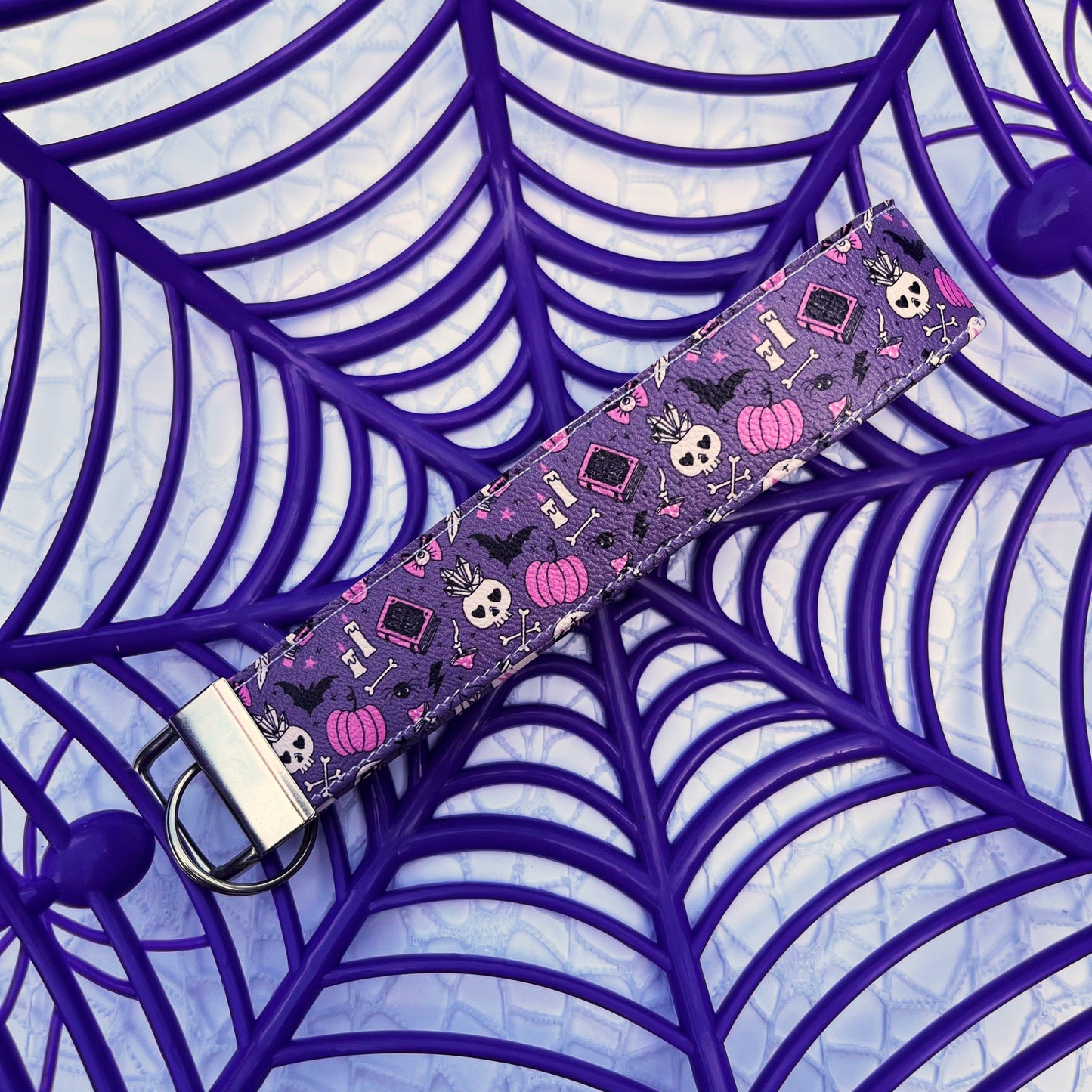 A witchcraft leatherette keychain wristlet.