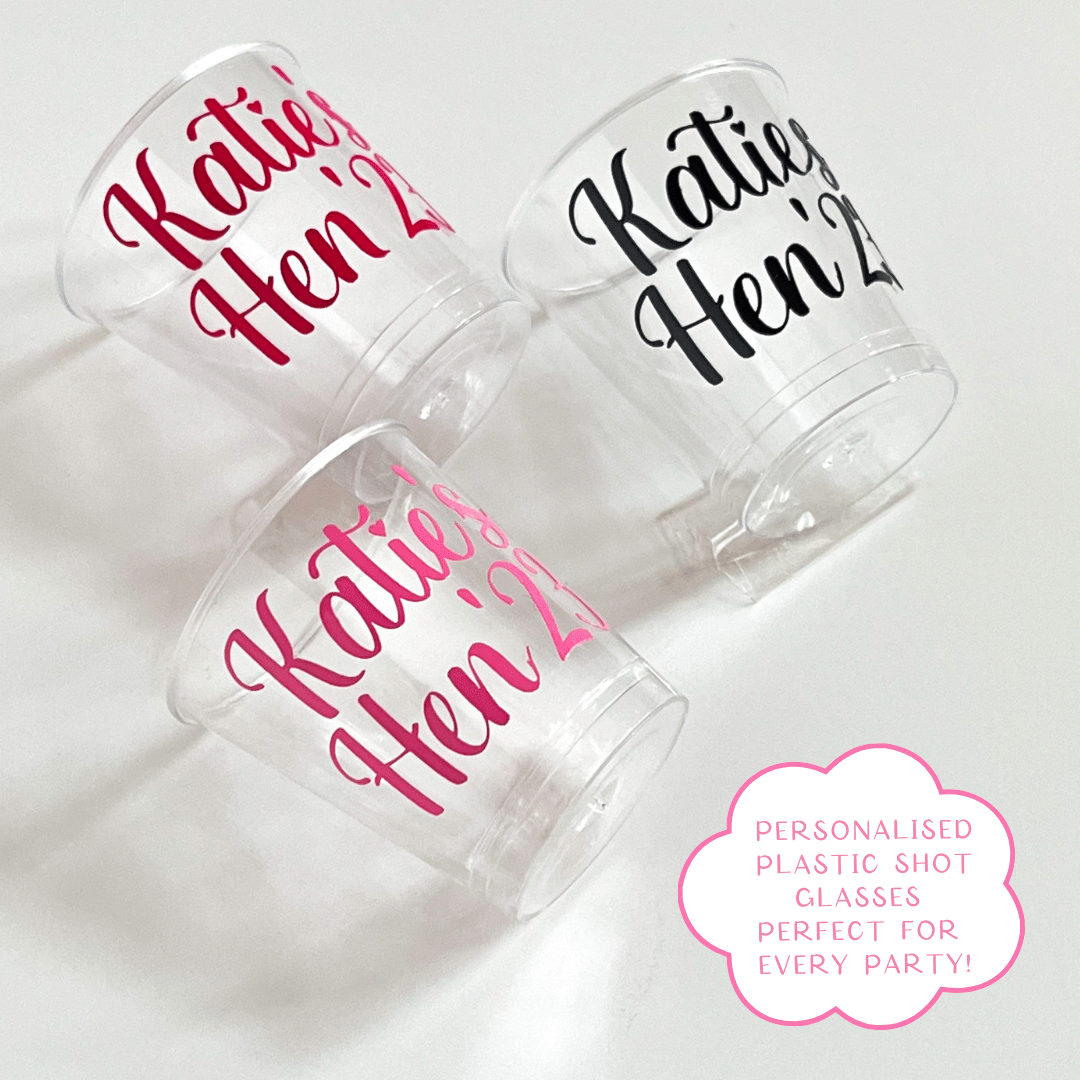 Personalised plastic hen party shot glasses.