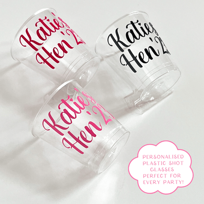 Personalised plastic hen party shot glasses.