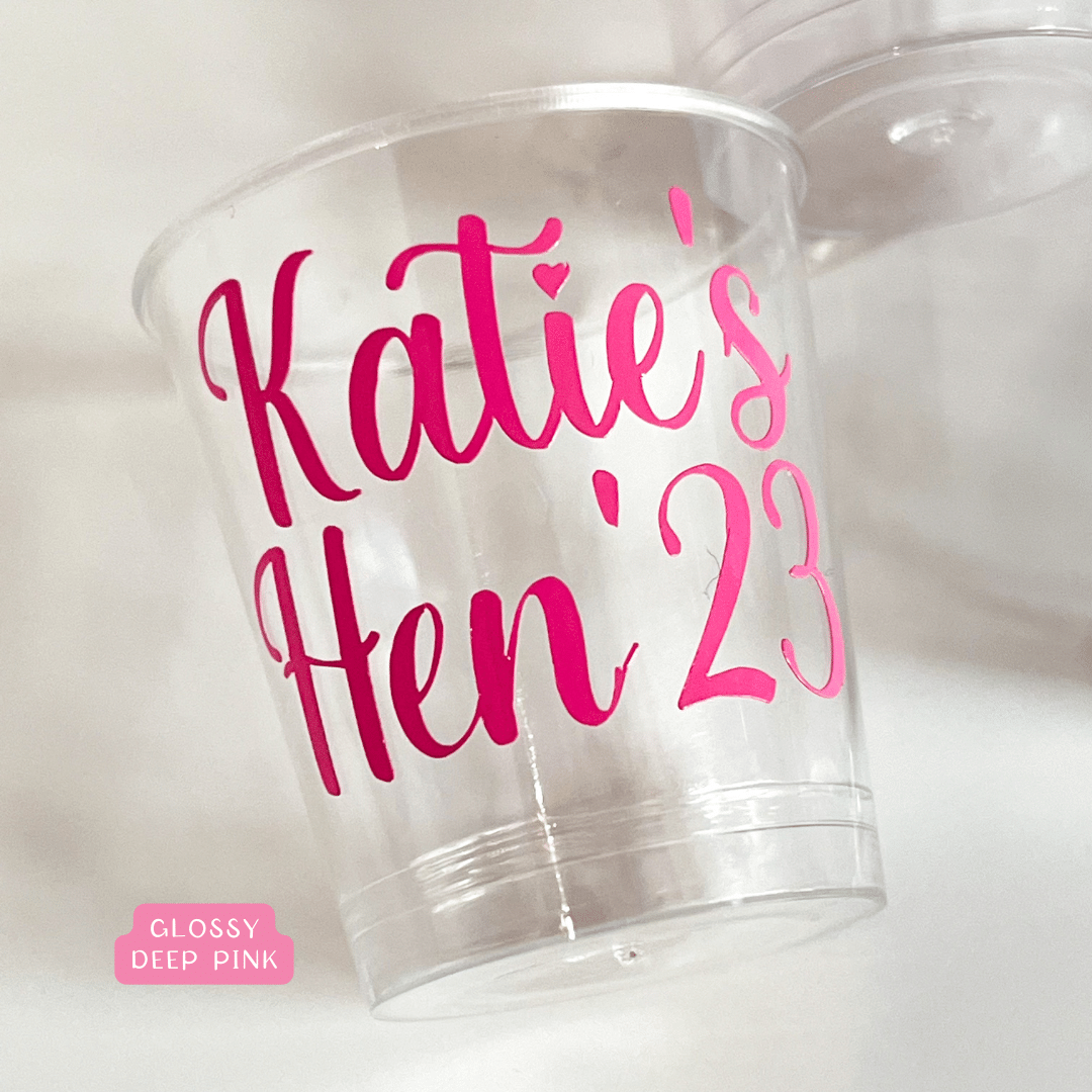 Personalised plastic hen party shot glasses.