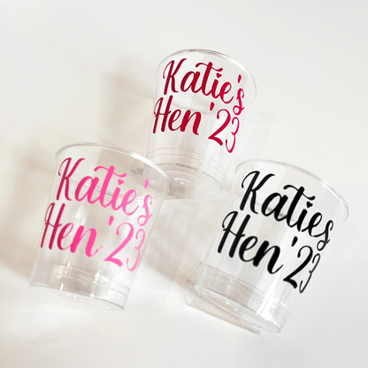 Personalised plastic hen party shot glasses.