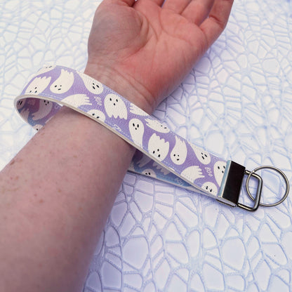 A ghost themed wrist lanyard, made of faux leather.